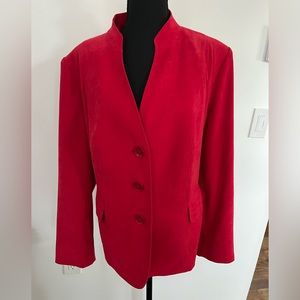 Women’s three button blazer. Two front pockets. Half belt on back.